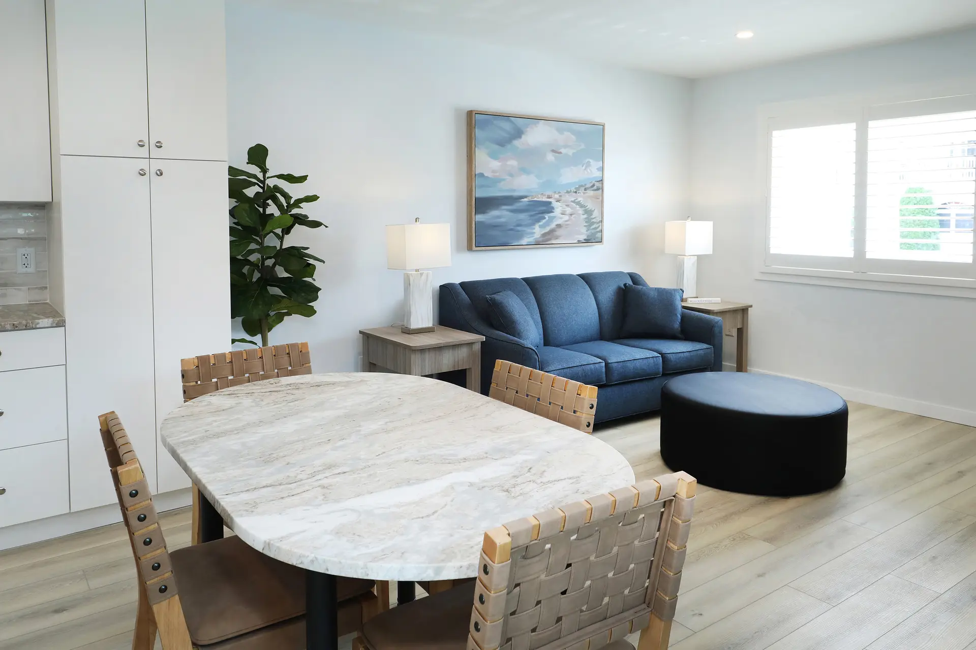 The renovated kitchen in a Matador apartment: full-size refrigerator, dishwasher, cooktop, microwave and stone worktops