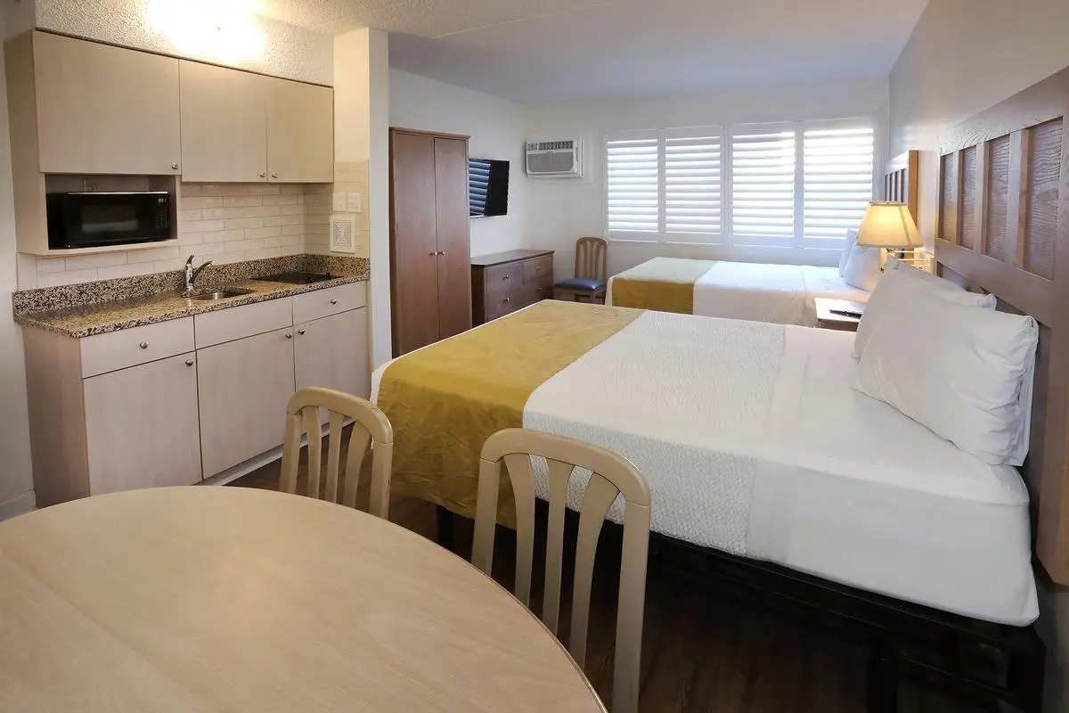 Type 3 One Room Efficiency at the Matador, with two beds and a kitchenette along the far wall
