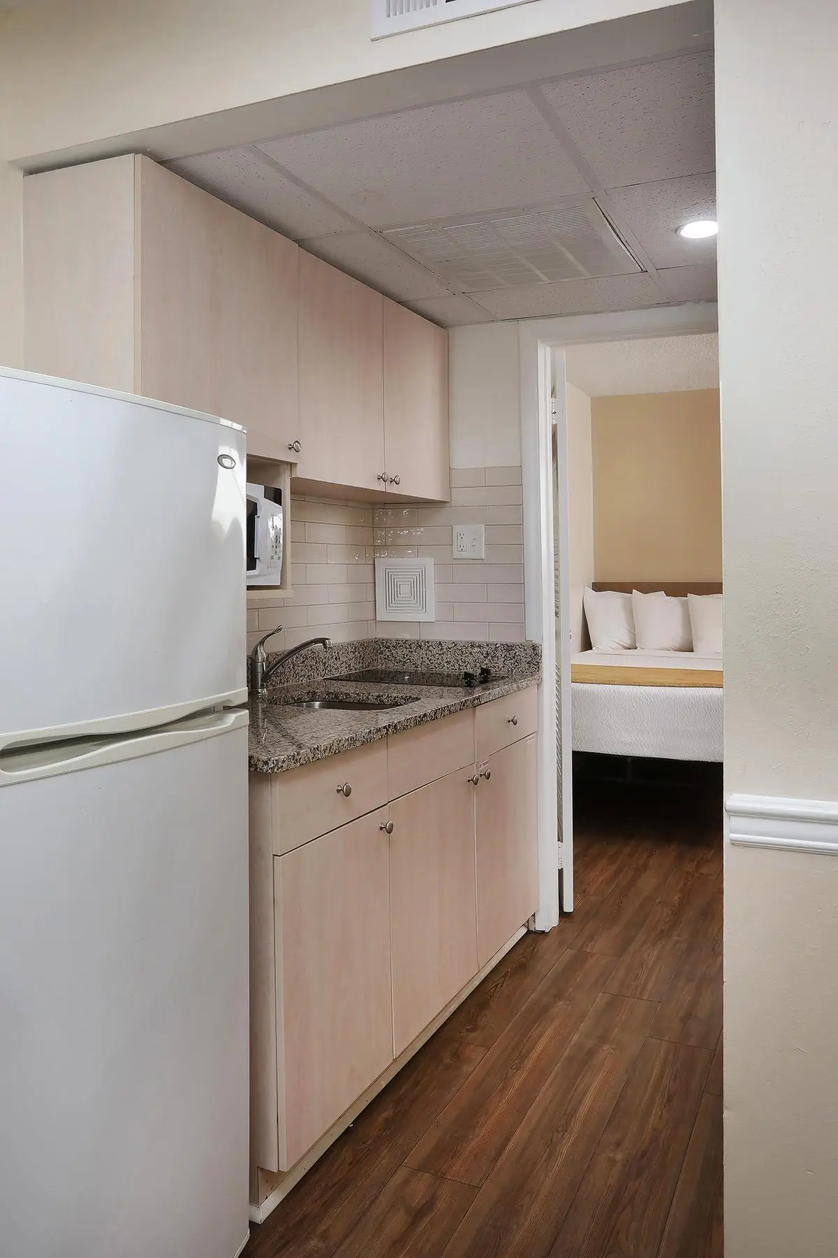 The kitchenette in a Type 6 Family Ocean View Efficiency at the Matador, stocked with cookware, dishware and silverware