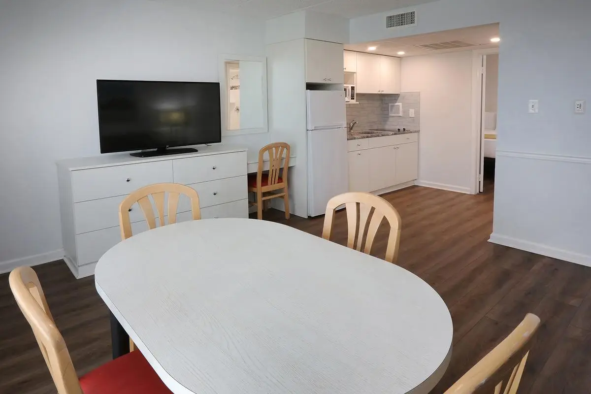 The dining table in a Type 7 Ocean Front Beach Suite at the Matador, set beside the balcony doors